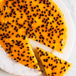 photo of passion fruit butter mochi cake sliced on a white plate