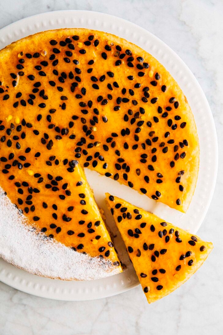 photo of passion fruit butter mochi cake sliced on a white plate
